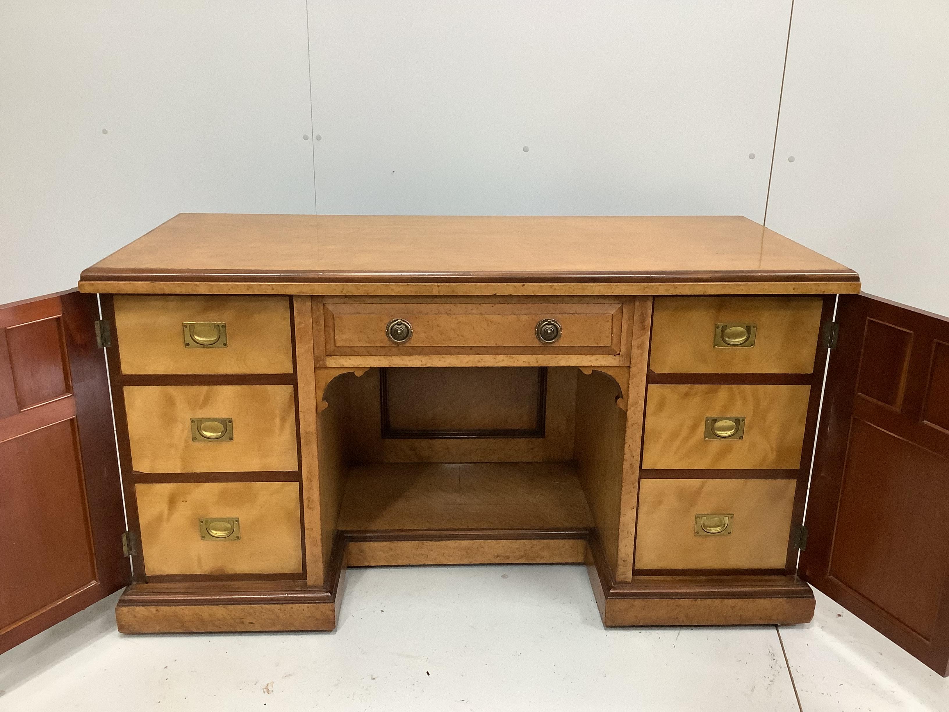 A late Victorian bird's eye maple kneehole desk by Moore and Hunton, London, width 140cm, depth 60cm, height 76cm